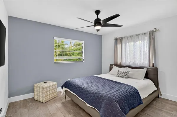 a bedroom with a bed and a painting on the wall