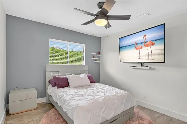 a bedroom with a bed and a window