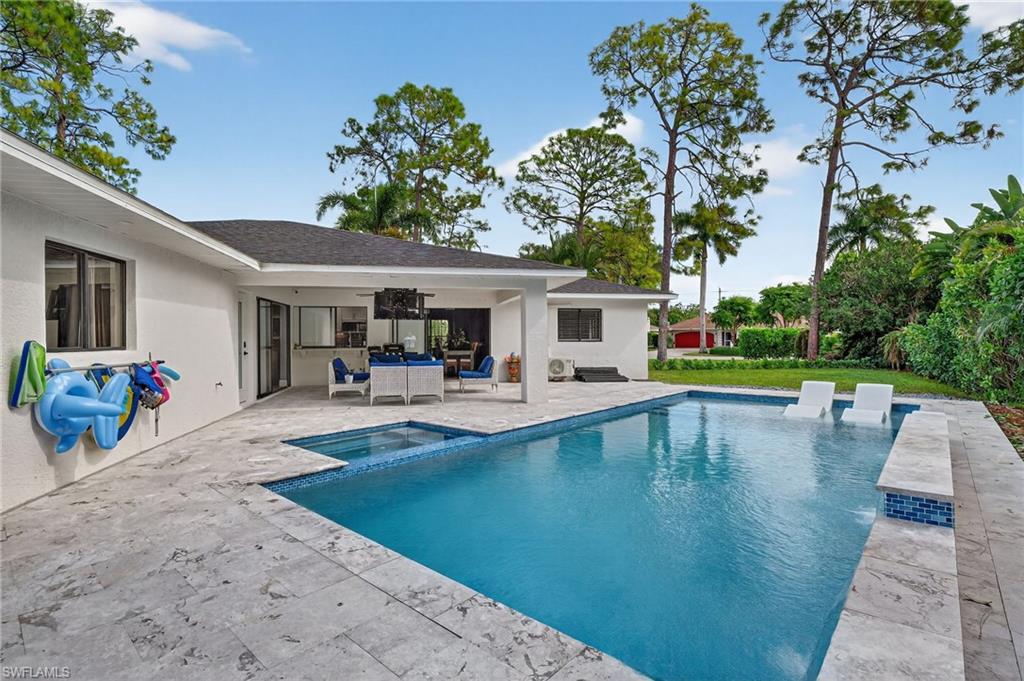 5270 Berkeley Drive Naples, FL 34112 - Photo 41 of 43 a view of a swimming pool with lounge chair