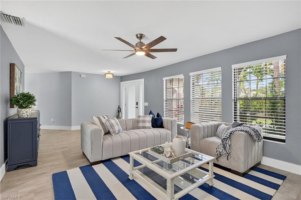 5270 Berkeley Drive Naples, FL 34112 - Photo 6 of 43 a living room with furniture and a large window