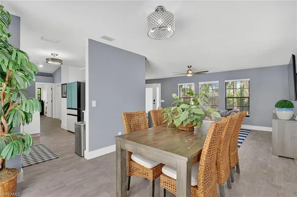 a view of a dining room with furniture window and wooden floor