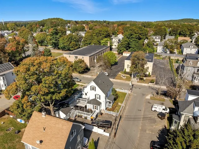 an aerial view of a house with a mountain