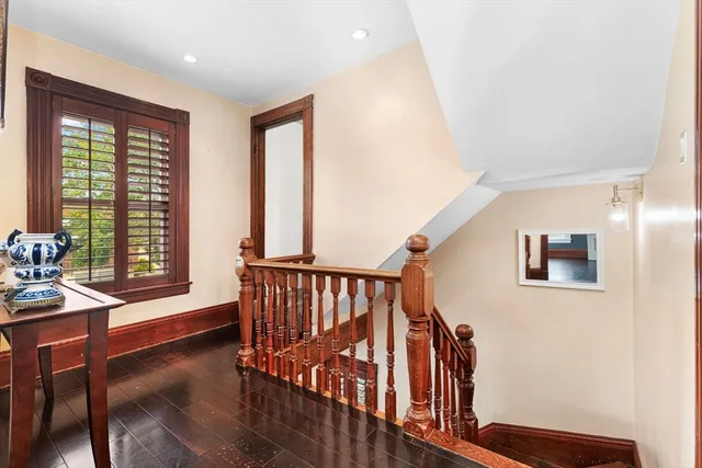 a bedroom with a bed and a dresser with mirror