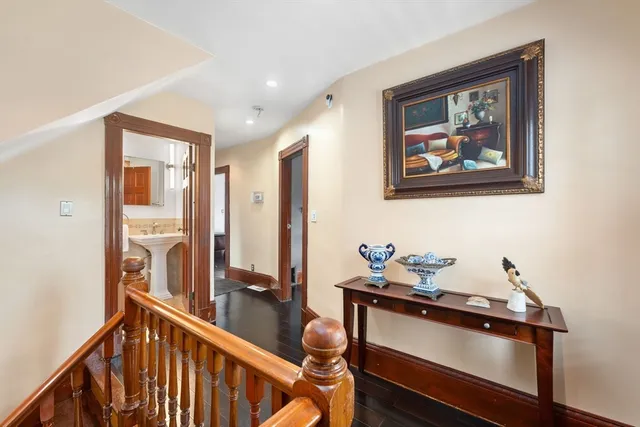 a bathroom with a granite countertop sink a toilet a mirror and shower