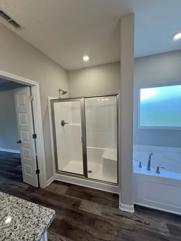 a bathroom with a bathtub and a shower