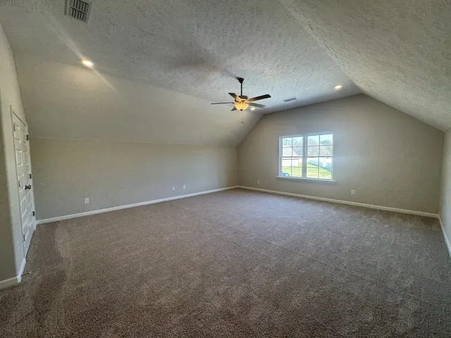 an empty room with a empty space and bathroom