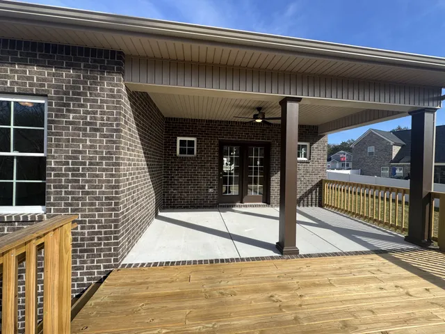 a backyard of a house with table and chairs