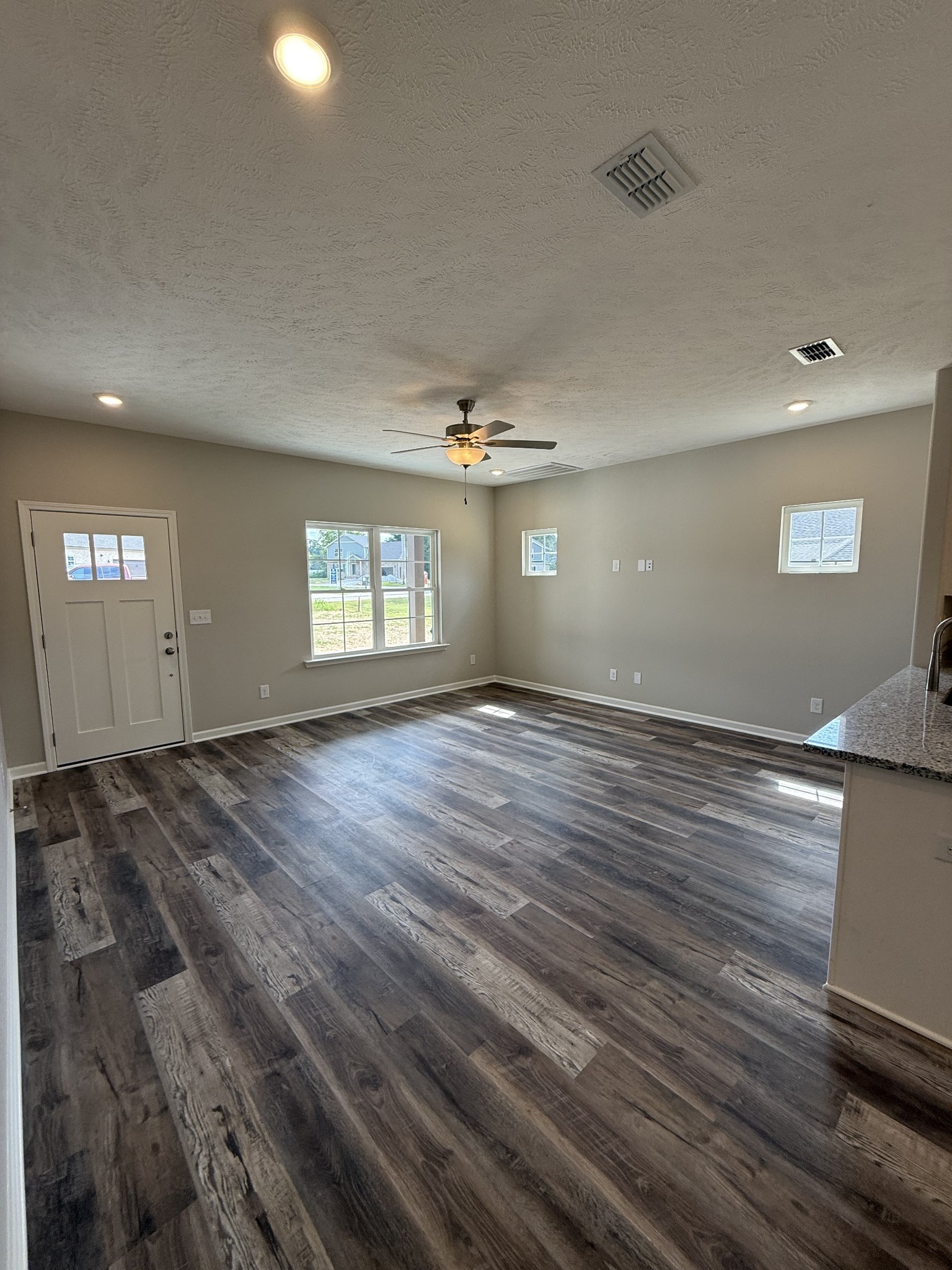 31 Spring House Drive Manchester, TN 37355 - Photo 4 of 32 an empty room with wooden floor and windows