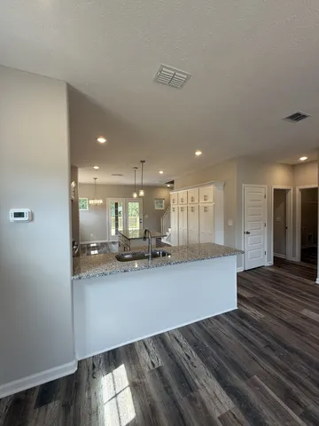 a large kitchen with sink and cabinets