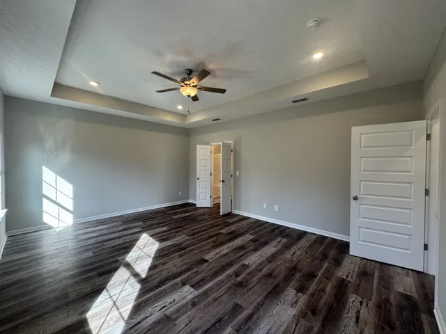 a view of an empty room window and wooden floor