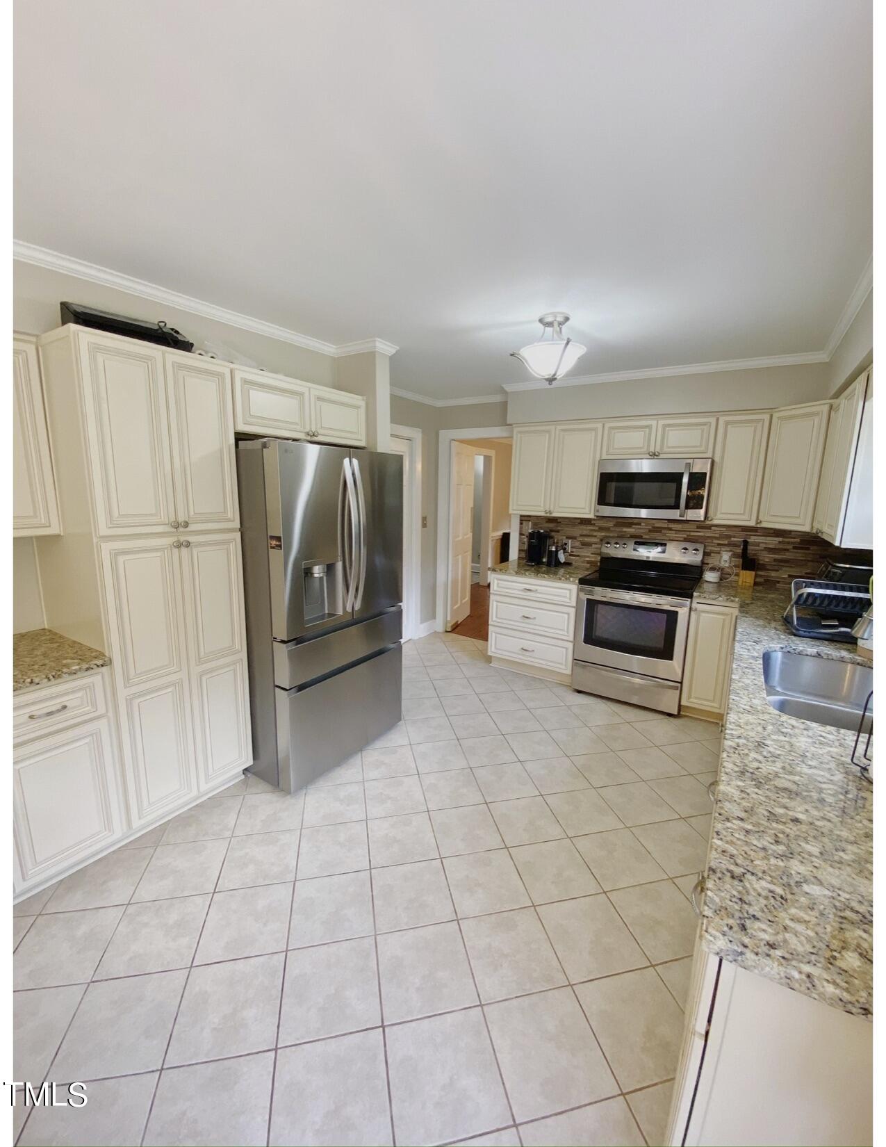 2000 Cayuga Place Raleigh, NC 27612 - Photo 13 of 31 a kitchen with stainless steel appliances granite countertop a refrigerator and a stove top oven