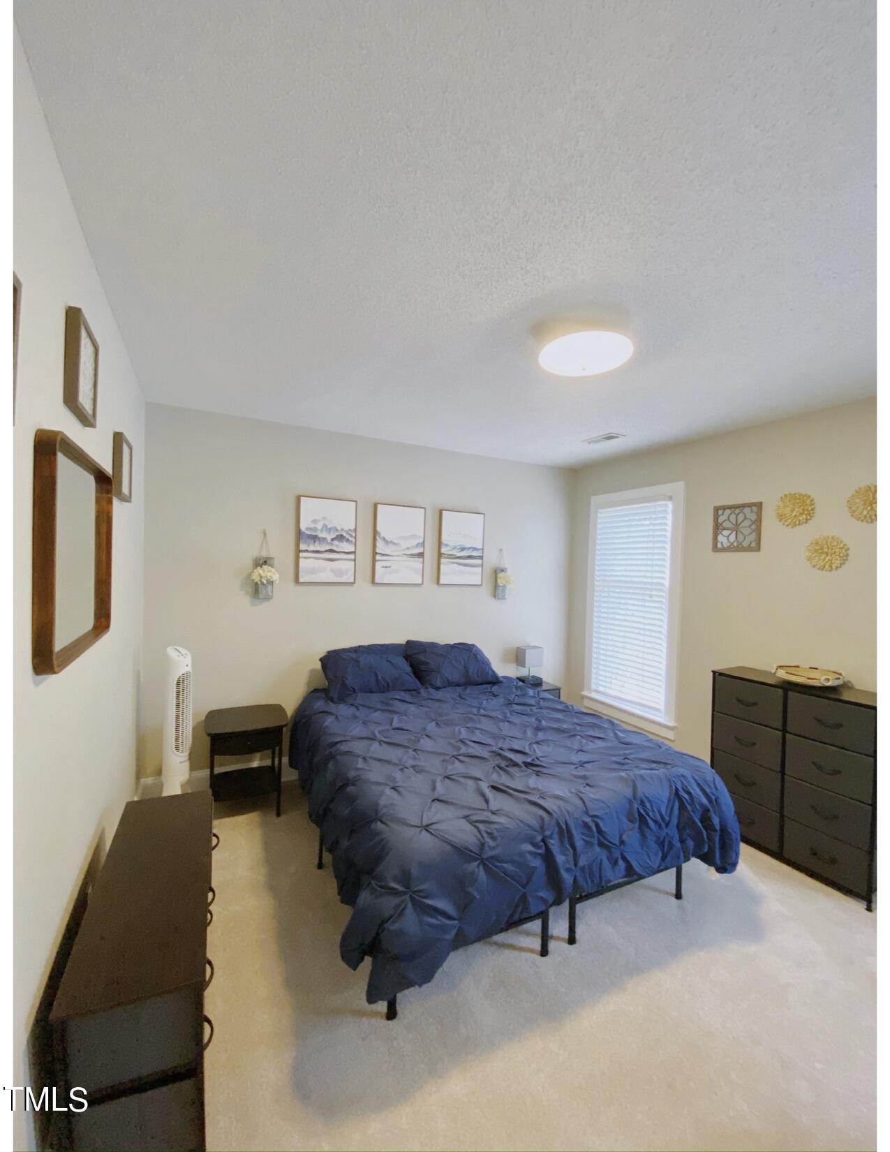 2000 Cayuga Place Raleigh, NC 27612 - Photo 30 of 31 a spacious bedroom with a bed and dresser