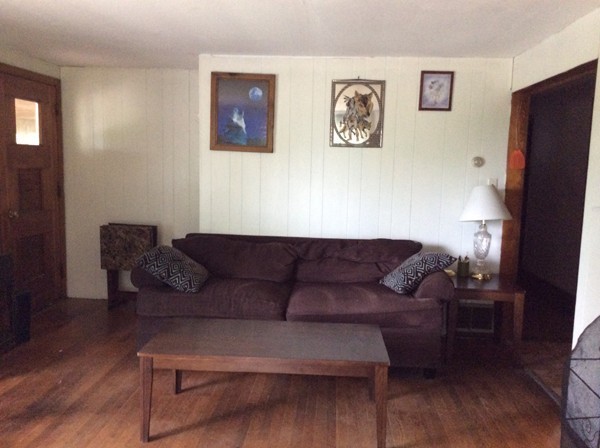 66 West Warren Road Ware, MA 01082 - Photo 11 of 25 a living room with furniture and a refrigerator