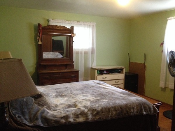 66 West Warren Road Ware, MA 01082 - Photo 13 of 25 a bedroom with a bed and a mirror