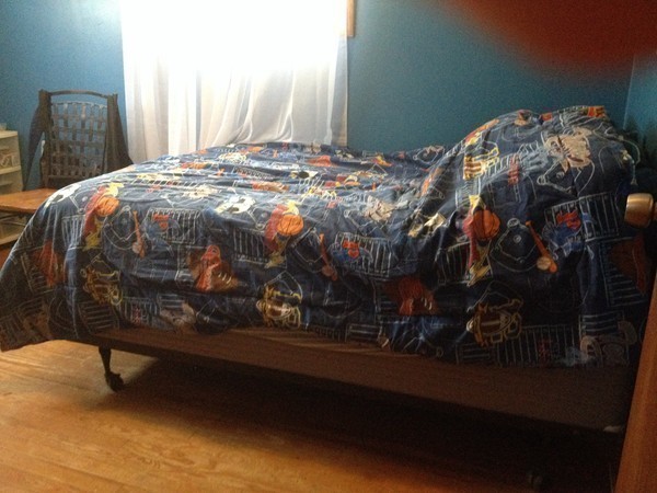 66 West Warren Road Ware, MA 01082 - Photo 15 of 25 a bed sitting in a bedroom next to a window