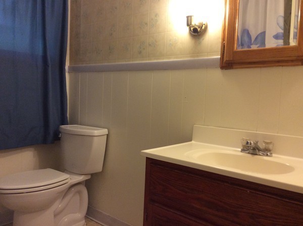 66 West Warren Road Ware, MA 01082 - Photo 17 of 25 a bathroom with a sink a toilet and a mirror
