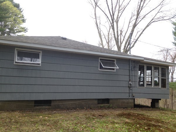 66 West Warren Road Ware, MA 01082 - Photo 2 of 25 a front view of a house with a yard