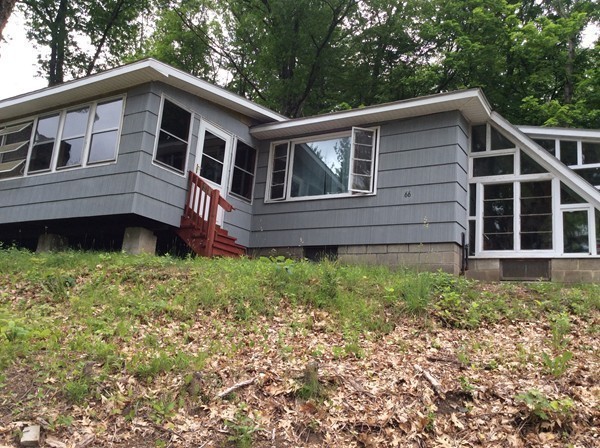 66 West Warren Road Ware, MA 01082 - Photo 3 of 25 a front view of a house with a garden