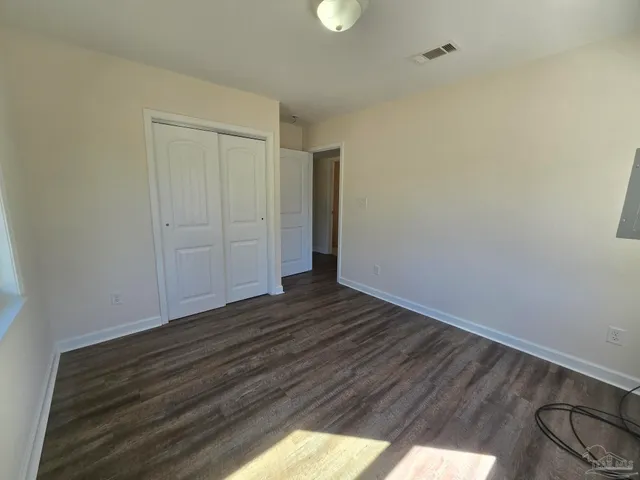 a view of an empty room and wooden floor