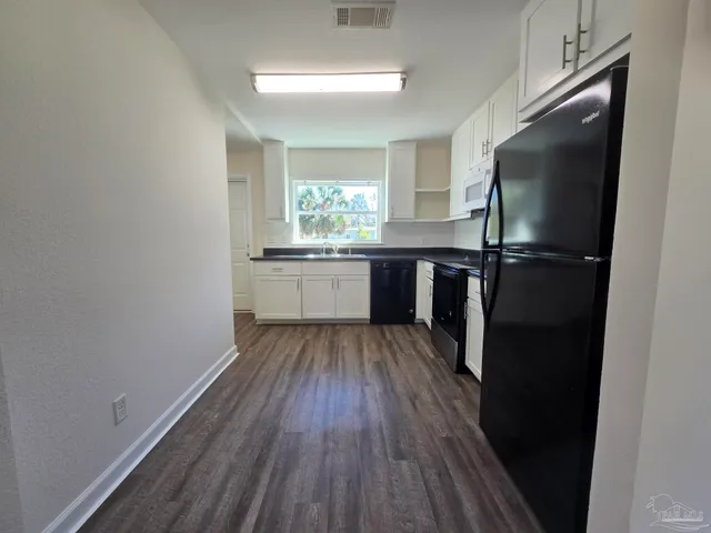 a kitchen with a sink and refrigerator