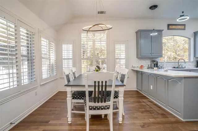 a view of a dining room with furniture and windows