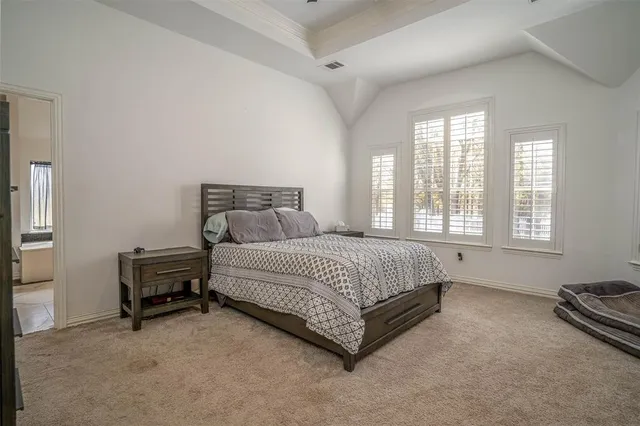 a spacious bedroom with a bed and a window