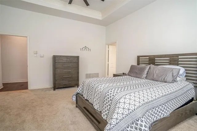 a bedroom with a bed and dresser