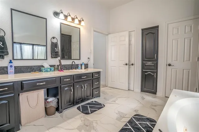 a spacious bathroom with a sink and a mirror