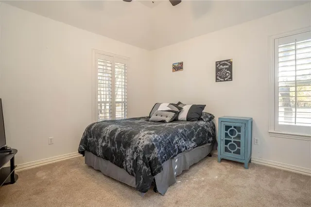 a spacious bedroom with a bed and a window