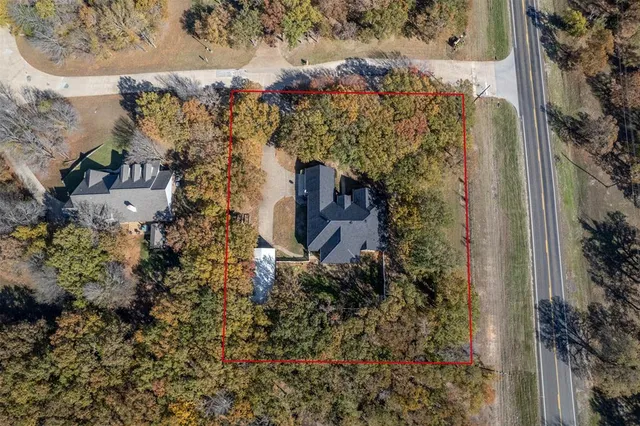a aerial view of a house with a yard and garden