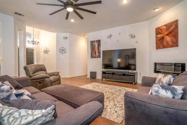 a living room with furniture and a flat screen tv