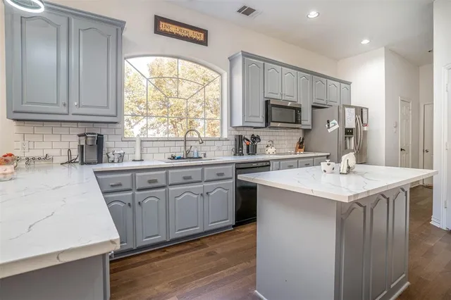 a kitchen with a sink stove and cabinets
