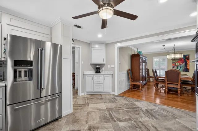 a kitchen with stainless steel appliances a refrigerator and microwave