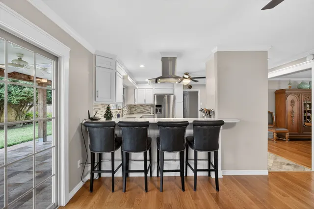 a dining room with furniture and wooden floor