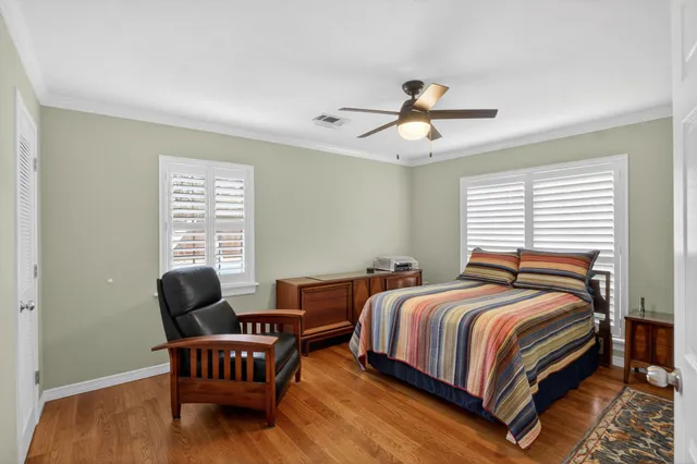 a bedroom with bed and a chair