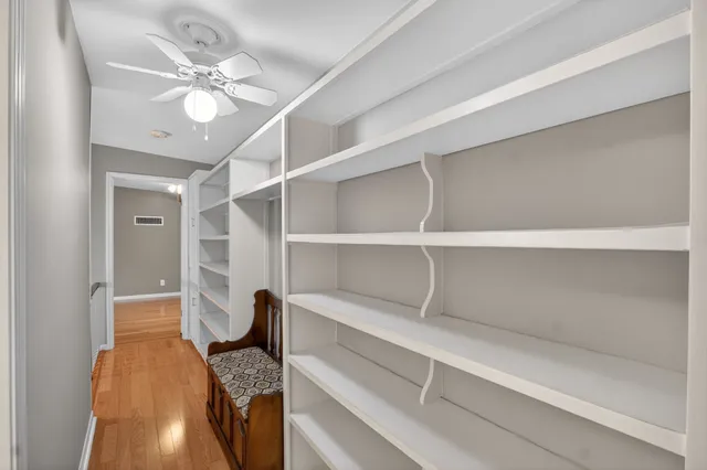 a view of a workspace with wooden floor