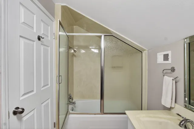 a bathroom with a shower and a mirror