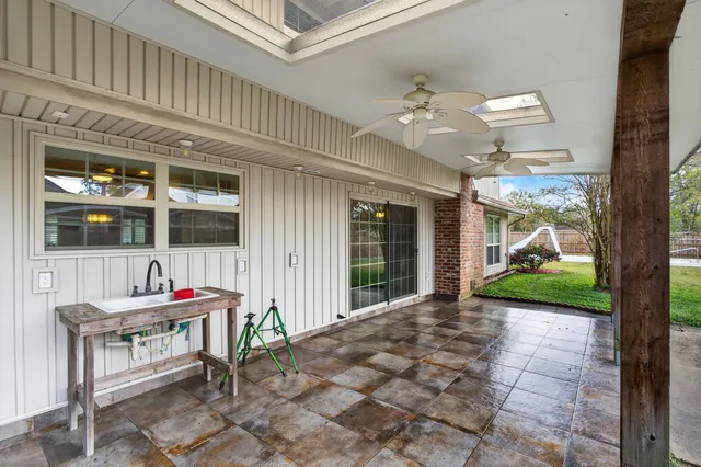 a front view of a house with outdoor seating and a potted plant