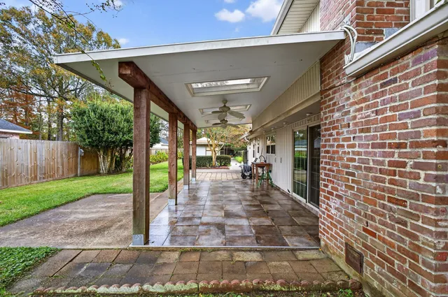 a view of a couches in the patio with a small yard