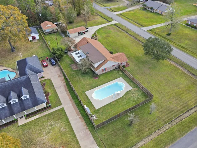 an aerial view of a house with a swimming pool