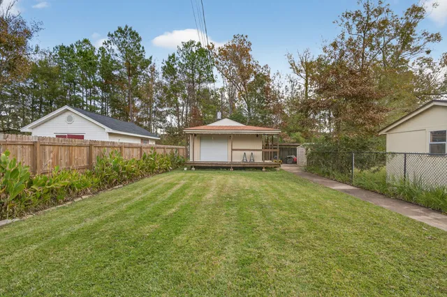 a front view of a house with a yard and trees