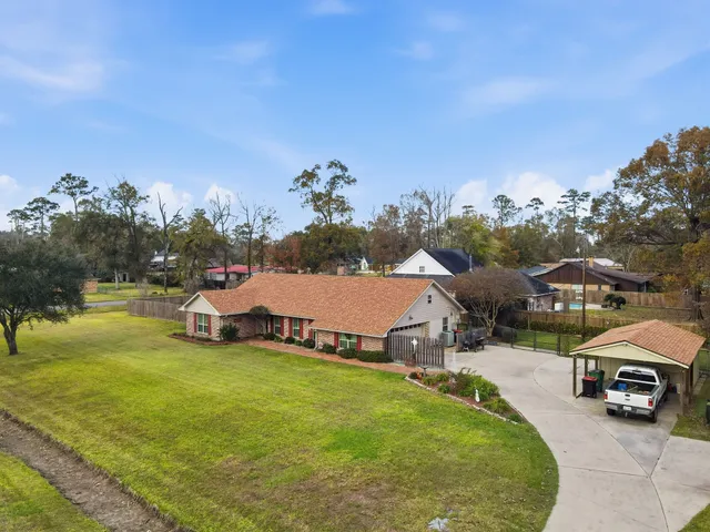 a view of a house with swimming pool and a yard
