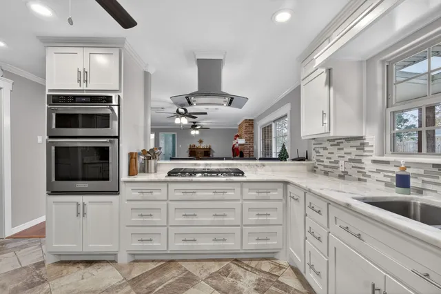 a kitchen with cabinets appliances and a sink