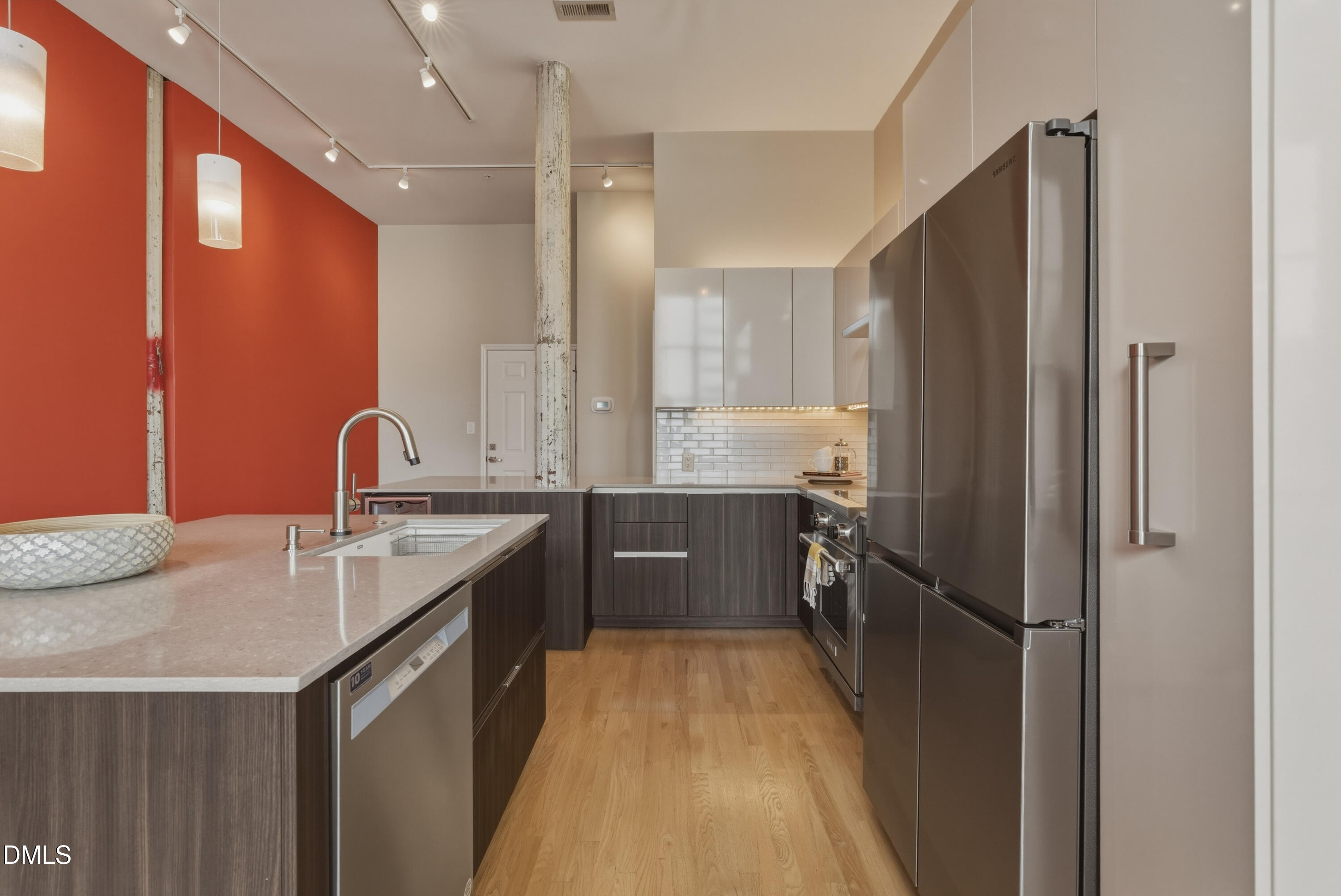 614 Capital Boulevard, Unit 114 Raleigh, NC 27603 - Photo 11 of 33 a kitchen with granite countertop a sink refrigerator and cabinets