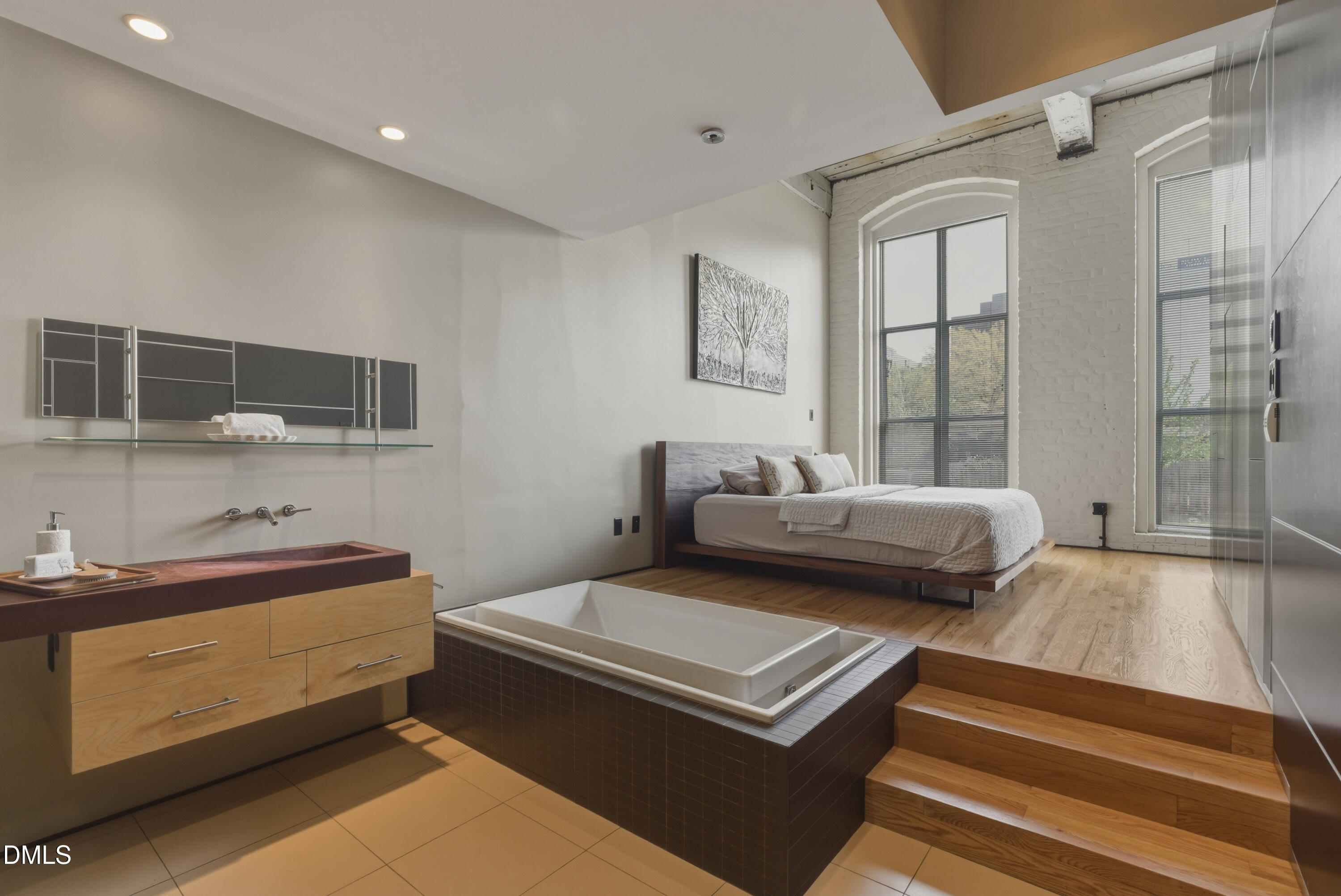 614 Capital Boulevard, Unit 114 Raleigh, NC 27603 - Photo 21 of 33 a bedroom with furniture and a flat screen tv