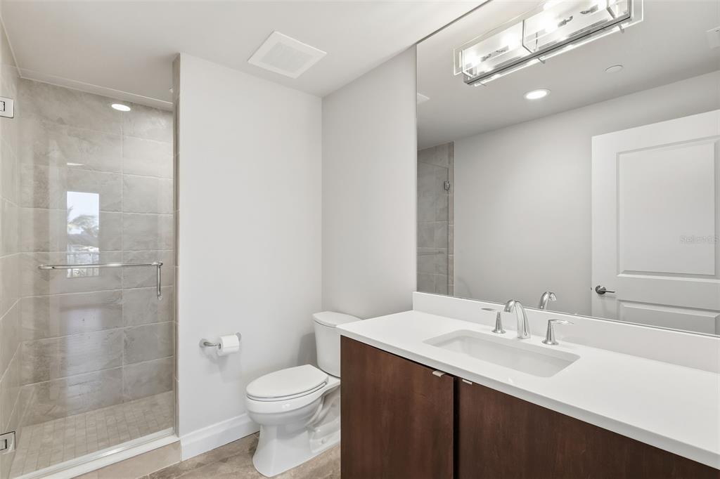 800 Collany Road, Unit 302 St. Petersburg, FL 33715 - Photo 48 of 66 a bathroom with a sink a toilet and shower