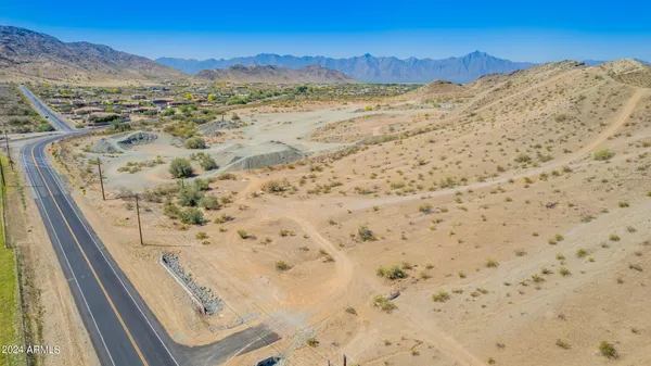 a view of a field with a mountain in the background