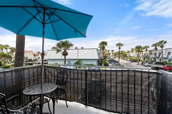 a view of a balcony with furniture and a umbrella