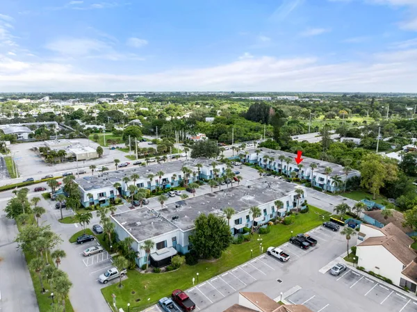 an aerial view of residential houses with outdoor space and trees
