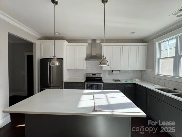 a kitchen with a refrigerator a sink and a stove